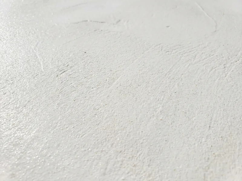 Close-up of a smooth white plaster pool finish